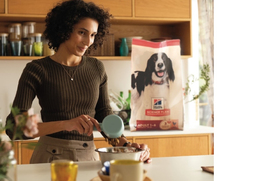 A woman serving hill's food on a bowl